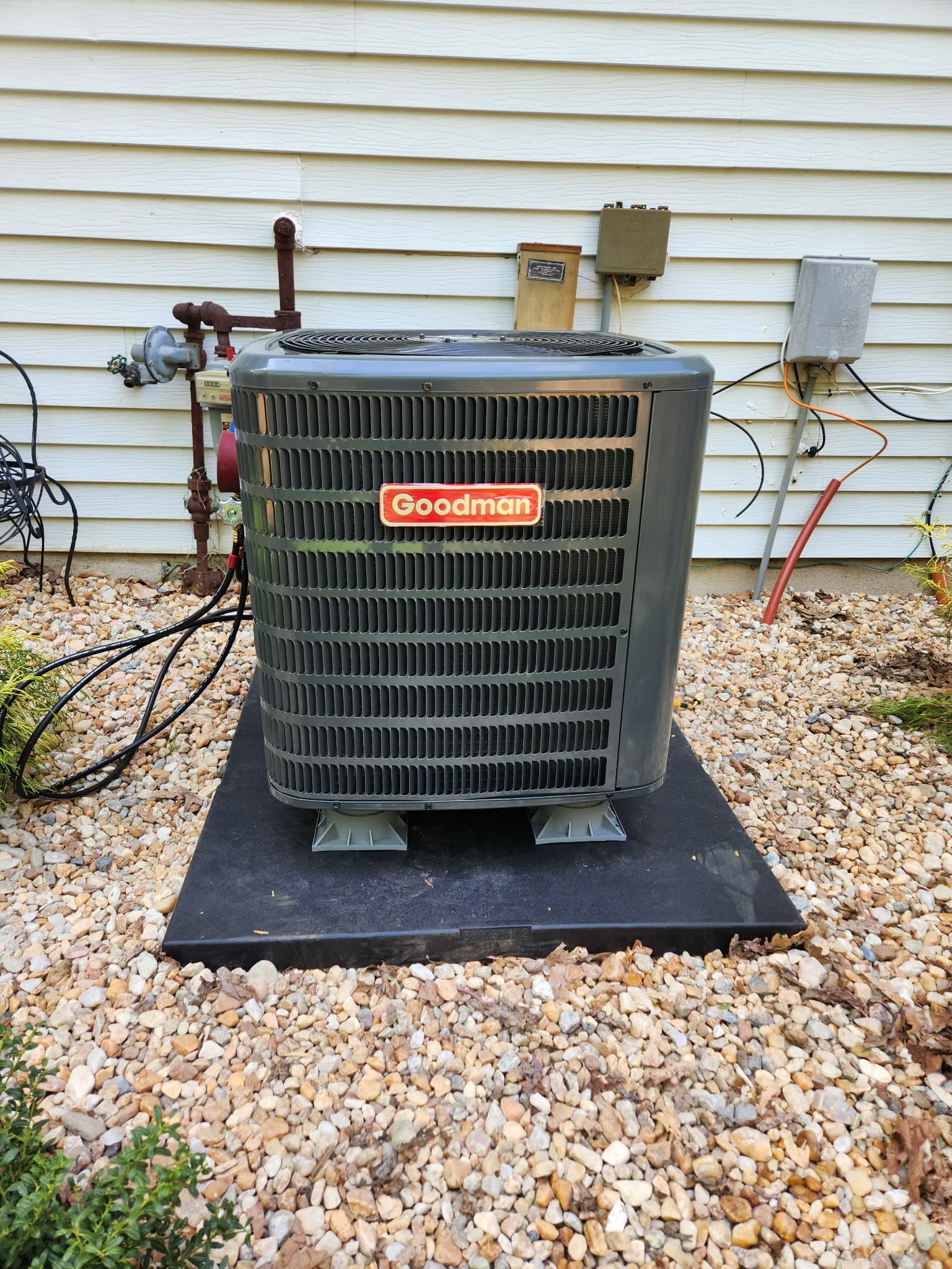 Outdoor AC condenser installation on rooftop